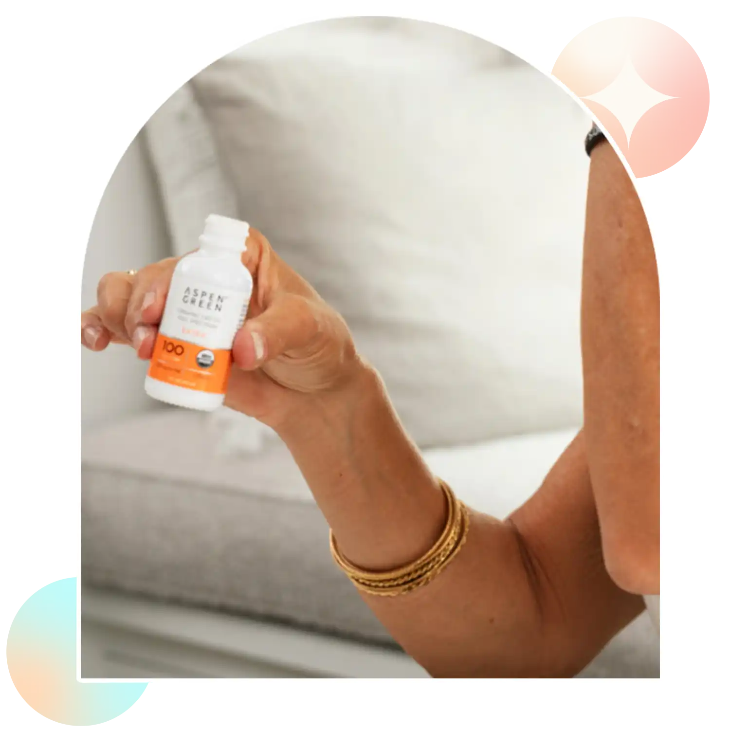 Woman holding Aspen Green Extra Citrus CBD oil bottle