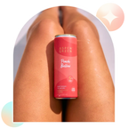 Aspen Green Peach Bellini 5mg THC beverage resting casually on a leg,