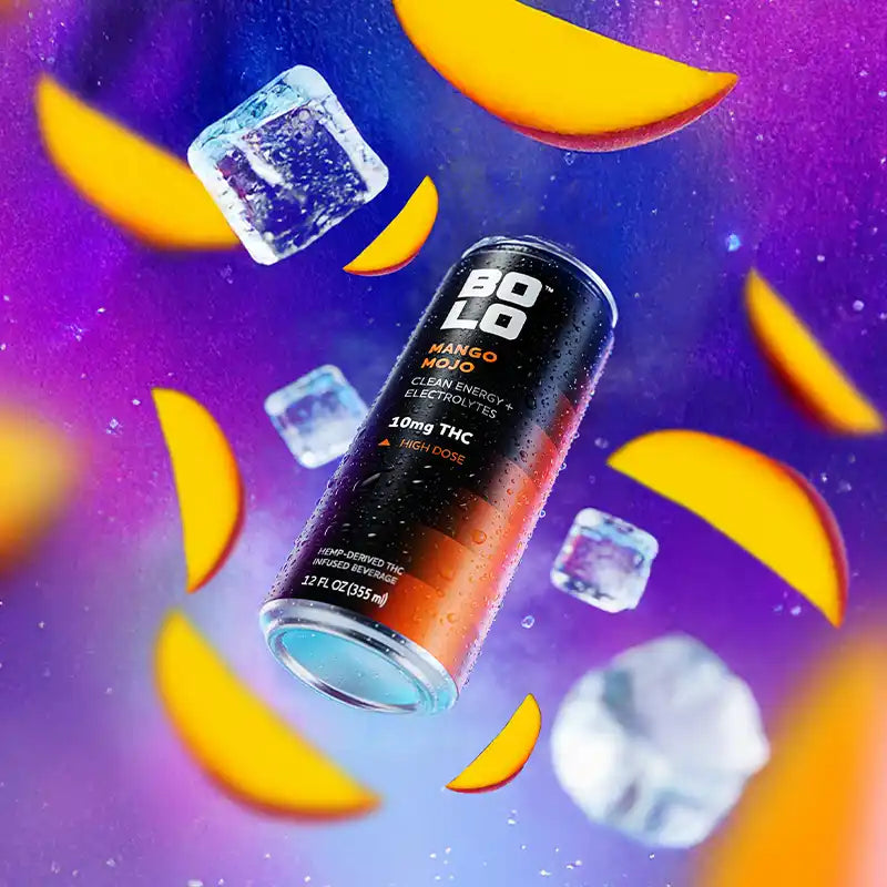 BOLO Mango Mojo THC-Infused Drink Surrounded by Ice and Sliced Mangos