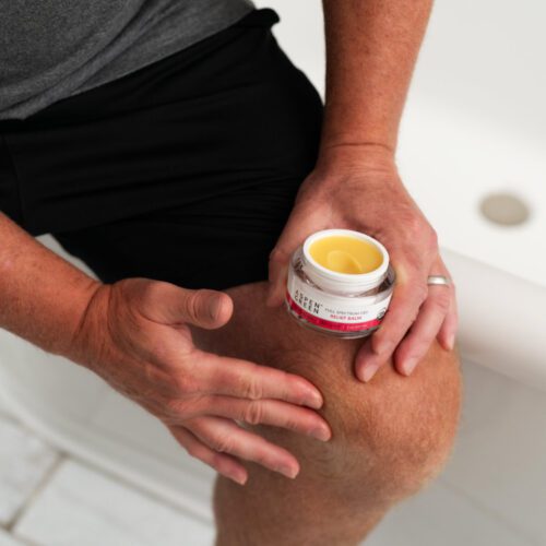 Man rubbing in Aspen Green Relief Balm on knee